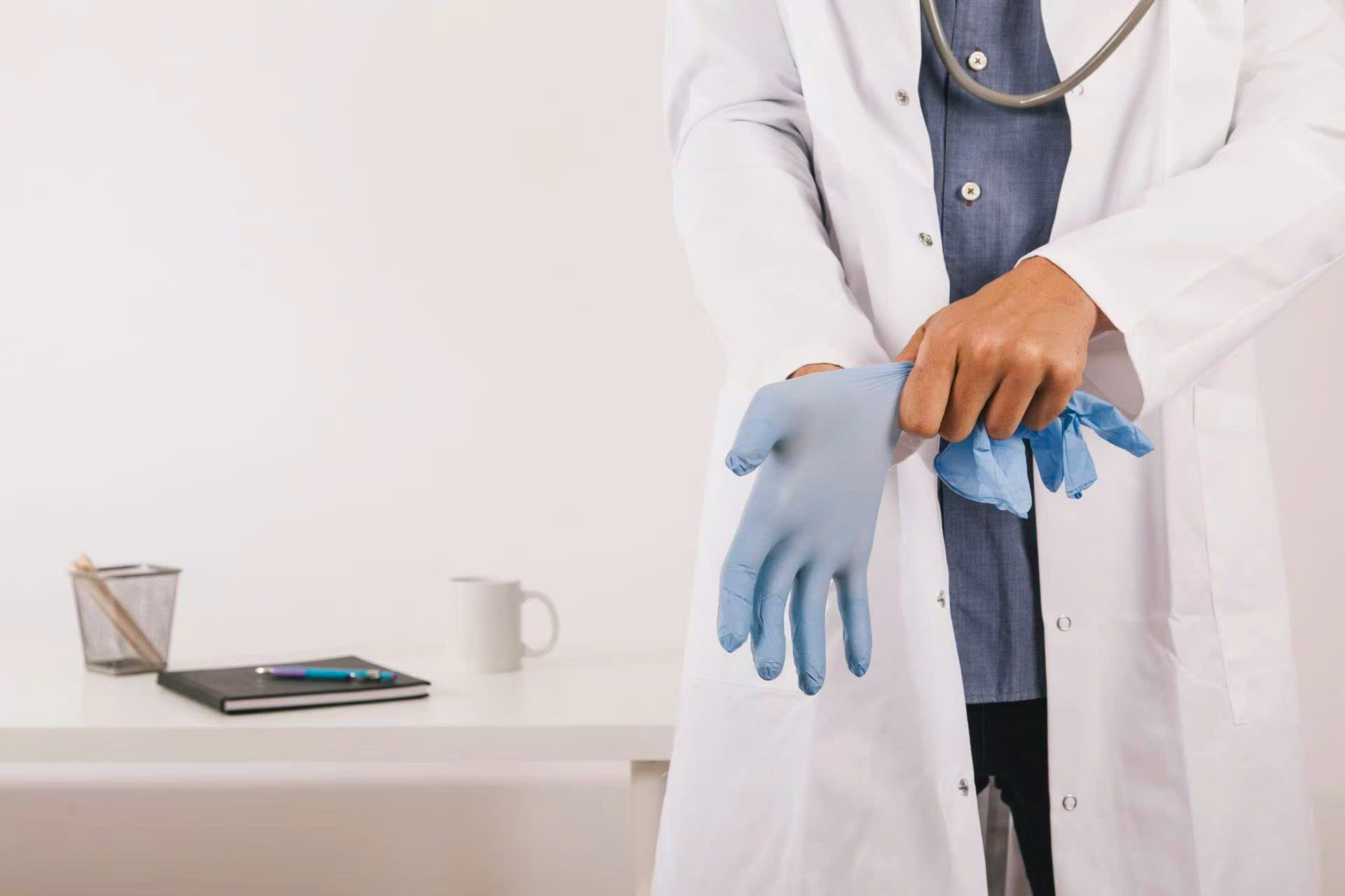 Thin rubber gloves fit tightly on hands, ensuring hygiene and preventing infection.