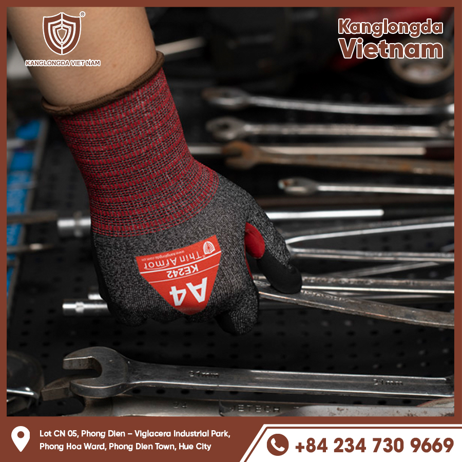 Gray-red protective gloves holding wrench in mechanics